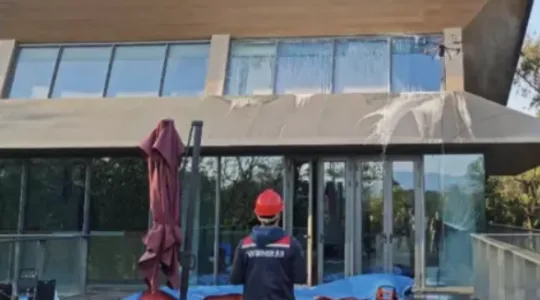 Two-person crew cleaning a building facade
