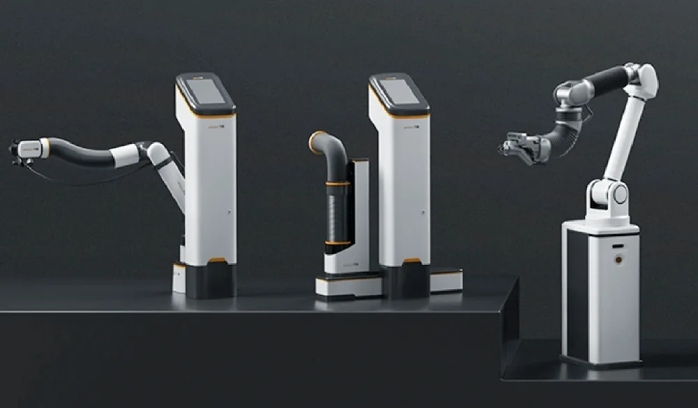Three Pliabot® manipulators on white columns in a dark studio